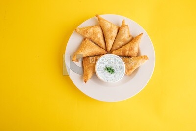 Plate of samosa with yogurt salad, popular dishes, appetizers, Arabic dishes, oriental dishes, restaurants for oriental Arabic food, delicious meals