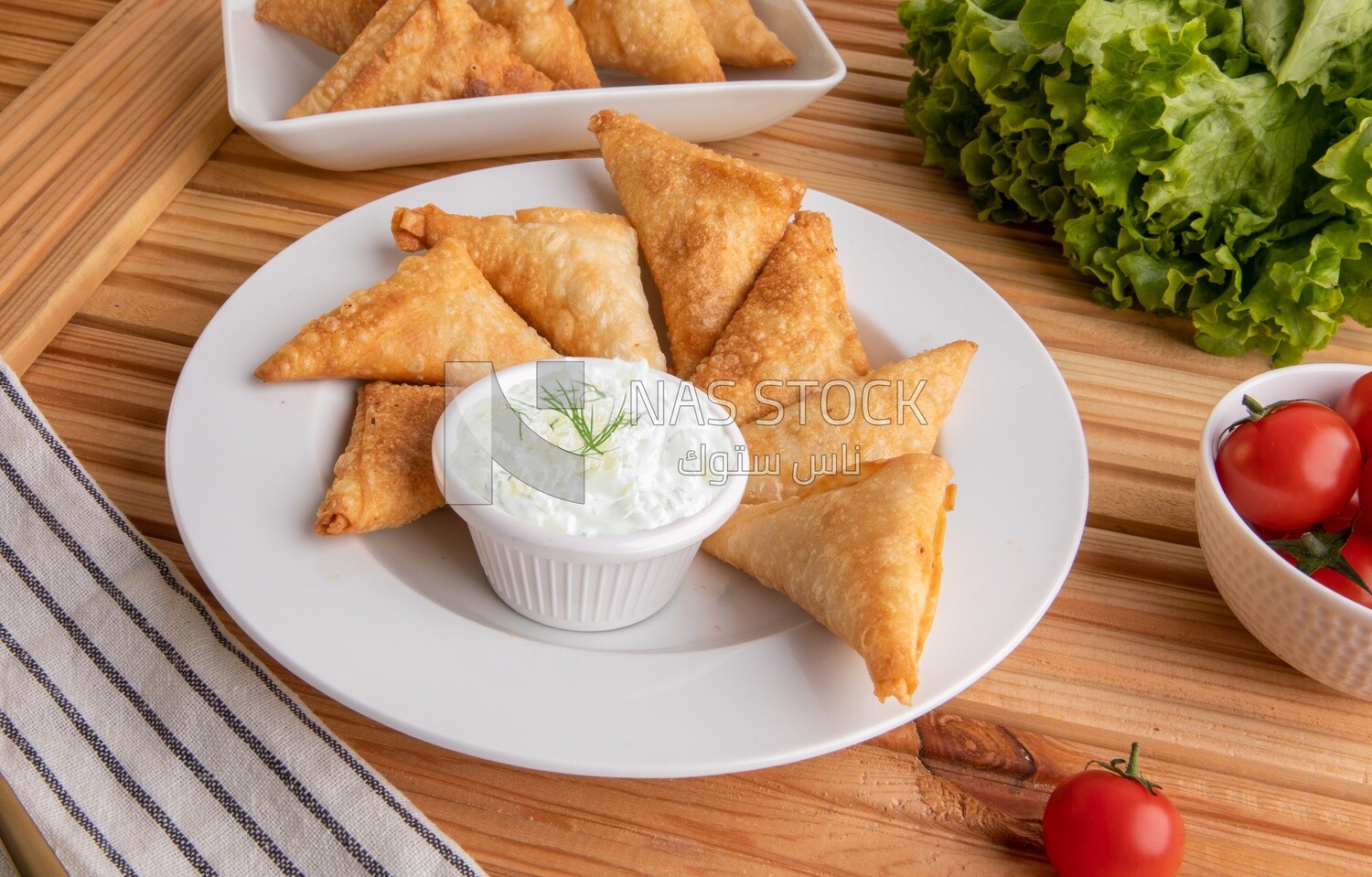 Plate of samosa with yogurt salad, popular dishes, appetizers, Arabic dishes, oriental dishes, restaurants for oriental Arabic food, delicious meals