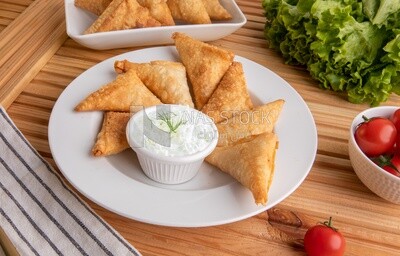 Plate of samosa with yogurt salad, popular dishes, appetizers, Arabic dishes, oriental dishes, restaurants for oriental Arabic food, delicious meals