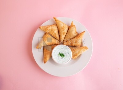Plate of samosa with yogurt salad, popular dishes, appetizers, Arabic dishes, oriental dishes, restaurants for oriental Arabic food, delicious meals