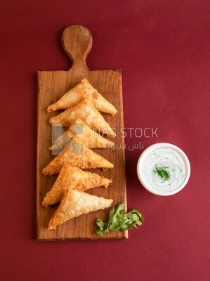 Plate of samosa with yogurt salad, popular dishes, appetizers, Arabic dishes, oriental dishes, restaurants for oriental Arabic food, delicious meals