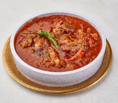 Bowl of trotters soup with red sauce, casserole of delicious trotter soup, Arabic meals, trotter soup