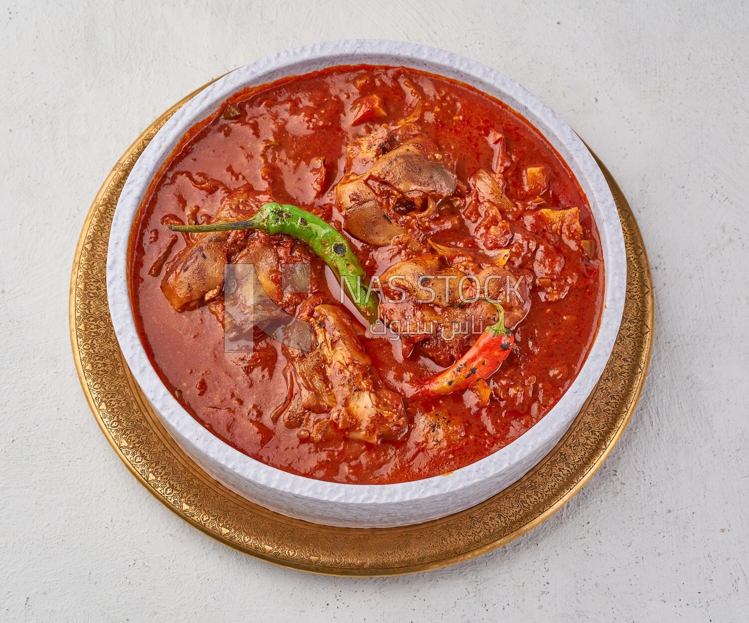Bowl of trotters soup with red sauce, casserole of delicious trotter soup, Arabic meals, trotter soup
