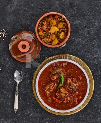 Bowl of trotters soup with red sauce and vegetable torly, casserole of delicious trotter soup, Arabic meals, trotter soup