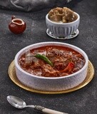 Bowl of trotters soup with red sauce, casserole of delicious trotter soup, Arabic meals, trotter soup