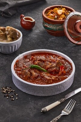 Bowl of trotters soup with red sauce, casserole of delicious trotter soup, Arabic meals, trotter soup