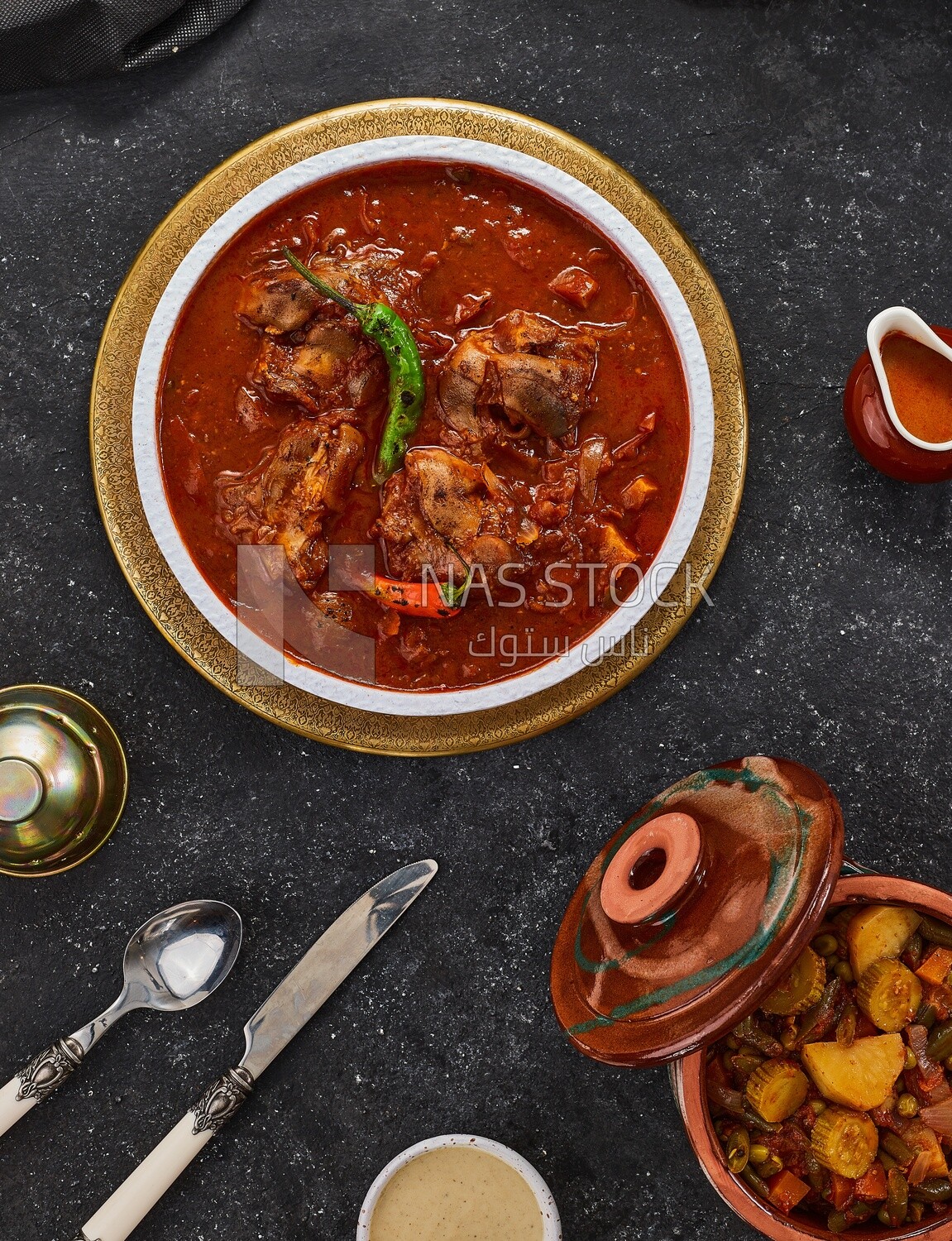 Bowl of trotters soup with red sauce, casserole of delicious trotter soup, Arabic meals, trotter soup