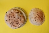 Arabic white bread, freshly baked, placed on a yellow background