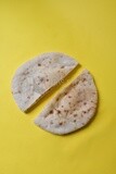 Arabic white bread, freshly baked, placed on a yellow background