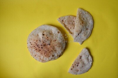 Arabic white bread, freshly baked, placed on a yellow background