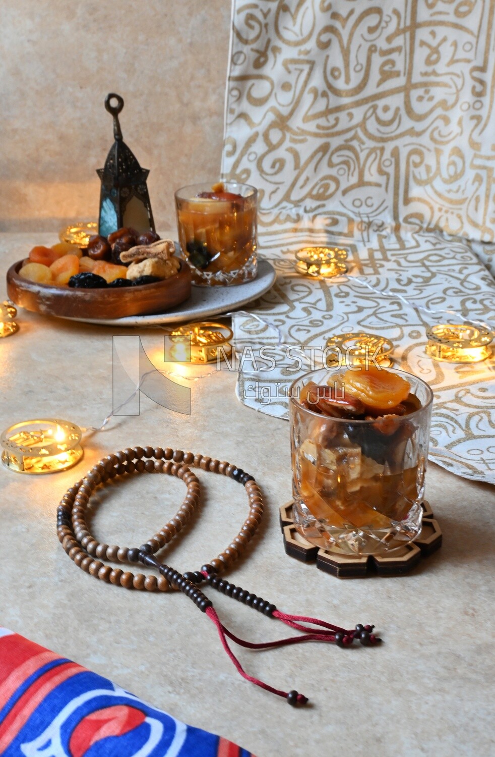 Two cups of khoshaf and a bowl full of khoshaf, Dried Fruit, and nuts salad, delicious dessert, Ramadan juice, delicious juice, traditional juice