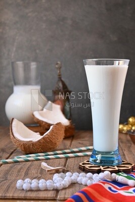 Cup of sobia beside a coconut, delicious dessert, Ramadan juice, delicious juice, traditional juice