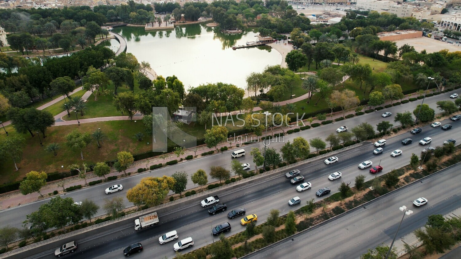 drone footage of Peace Park Lake in Riyadh, view of car traffic, Saudi Arabia, tourist attractions in Riyadh, tourism in Saudi Arabia, natural view, famous Riyadh landmarks.