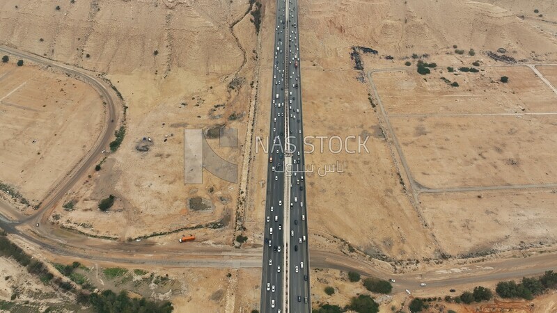 Drone footage of the suspension bridge in Riyadh, Saudi Arabia, Wadi Laban Bridge, architecture, traffic and cars, famous Riyadh landmarks.4K