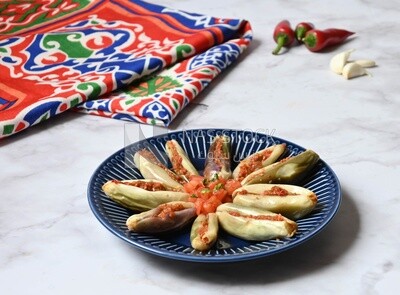 Plate of Pickled eggplant with sauce in it beside garlic and red pepper, Egyptian pickles, Arabic restaurants