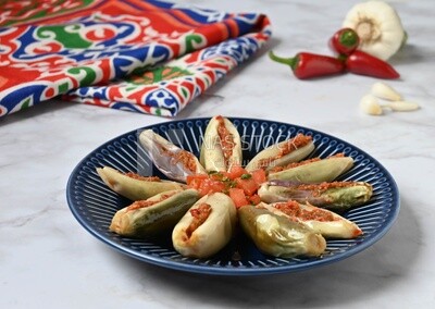 Plate of Pickled eggplant with sauce in it beside garlic and red pepper, Egyptian pickles, Arabic restaurants