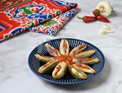 Plate of Pickled eggplant with sauce in it beside garlic and red pepper, Egyptian pickles, Arabic restaurants