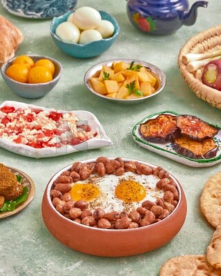 Dish of foul medames with fried egg, cheese with tomato, Arabic breakfast, oriental breakfast, arab restaurant
