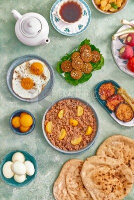 Dish of foul medames, falafel tablets, a plate of fried egg, Arabic breakfast, oriental breakfast, arab restaurant