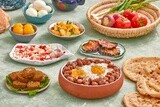 Dish of foul medames with fried egg, falafel tablets, cheese with tomato, Arabic breakfast, oriental breakfast, arab restaurant