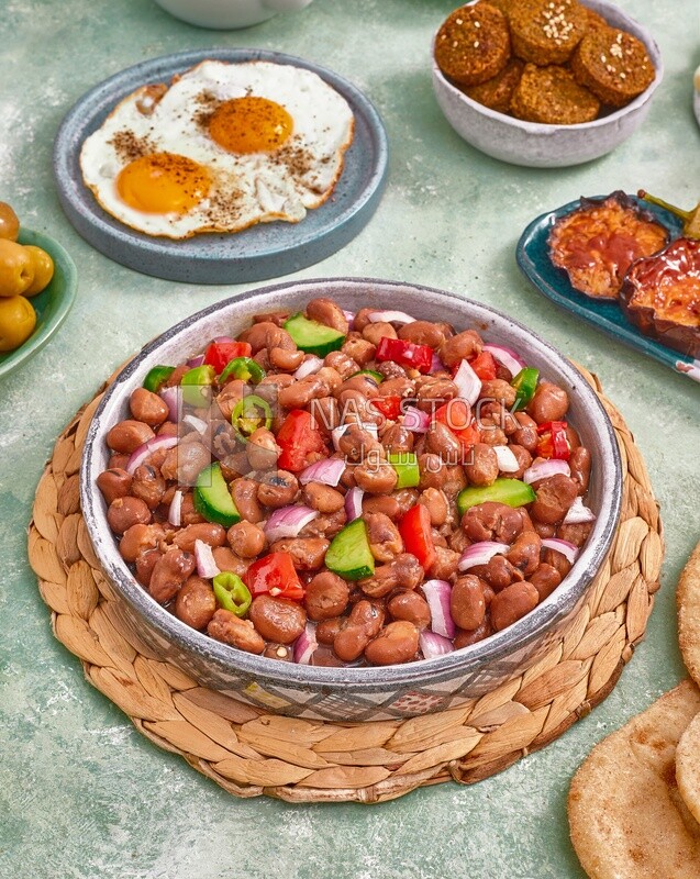 close-up of a dish of foul medames with vegetables, Arabic breakfast, oriental breakfast, arab restaurant