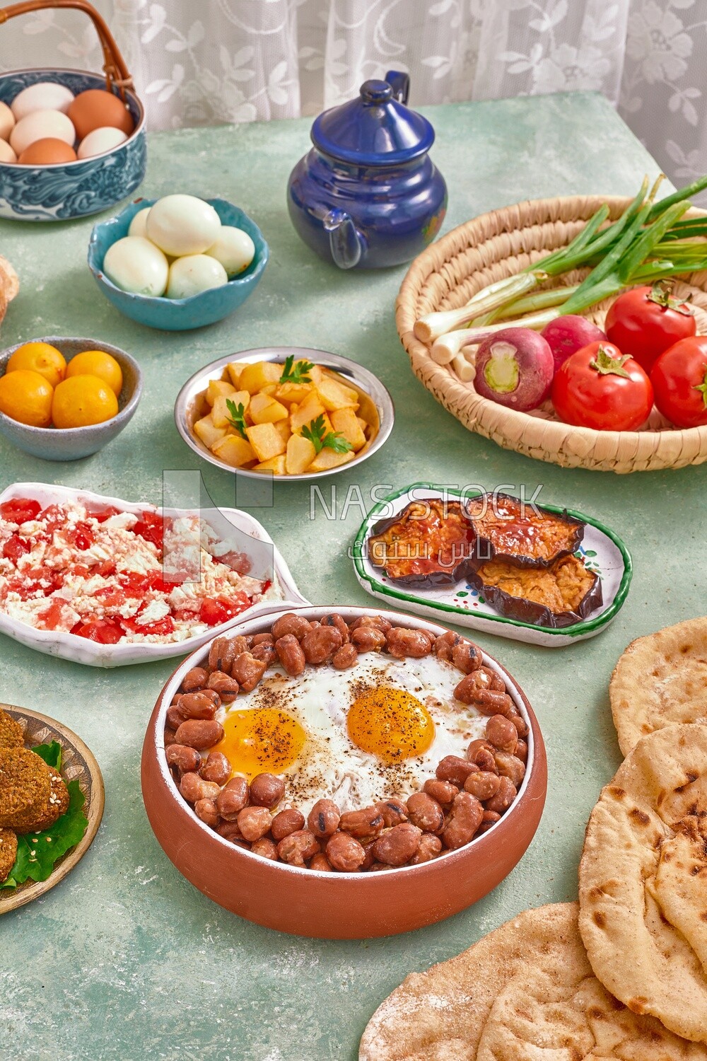 Dish of foul medames with fried egg, cheese with tomato, Arabic breakfast, oriental breakfast, arab restaurant