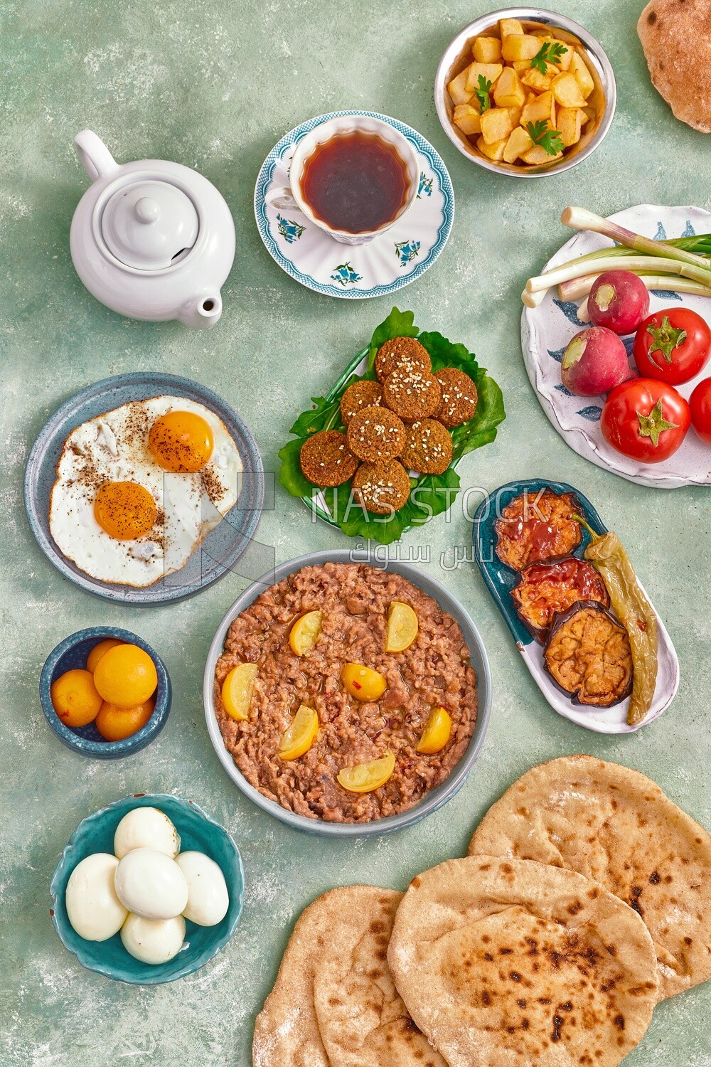 Dish of foul medames, falafel tablets, a plate of fried egg, Arabic breakfast, oriental breakfast, arab restaurant