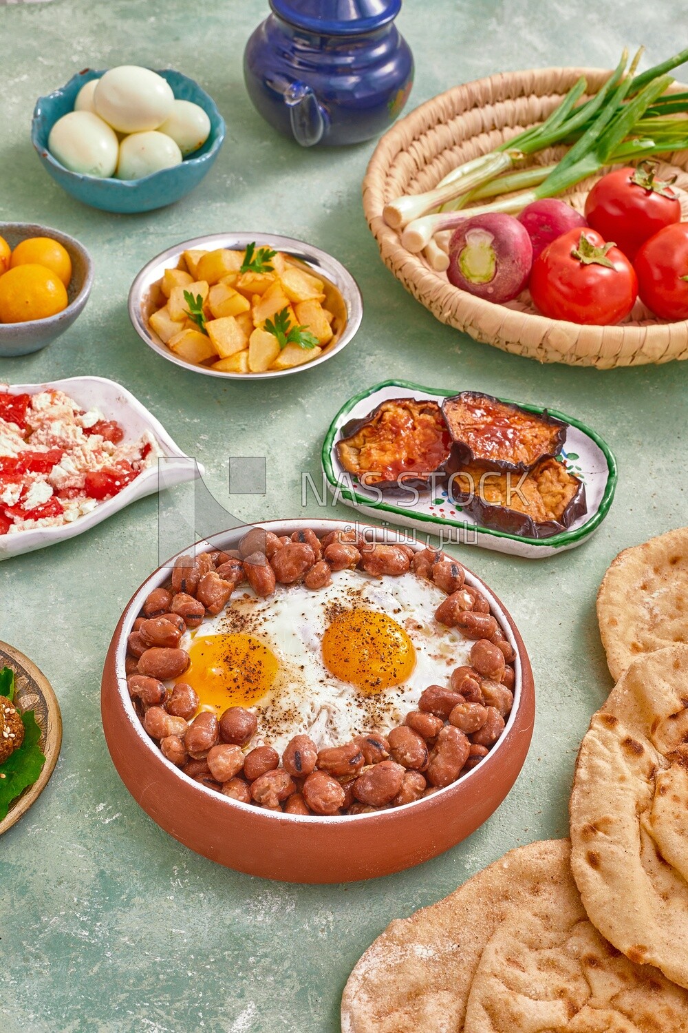 Dish of foul medames with fried egg, cheese with tomato, Arabic breakfast, oriental breakfast, arab restaurant