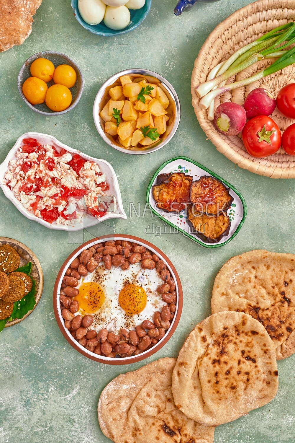 Dish of foul medames with fried egg, cheese with tomato, Arabic breakfast, oriental breakfast, arab restaurant
