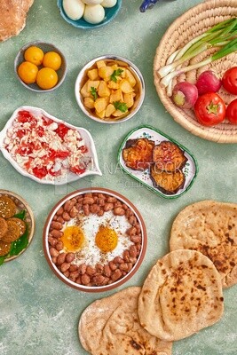 Dish of foul medames with fried egg, cheese with tomato, Arabic breakfast, oriental breakfast, arab restaurant