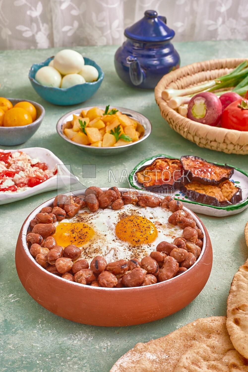 Dish of foul medames with fried egg, cheese with tomato, Arabic breakfast, oriental breakfast, arab restaurant