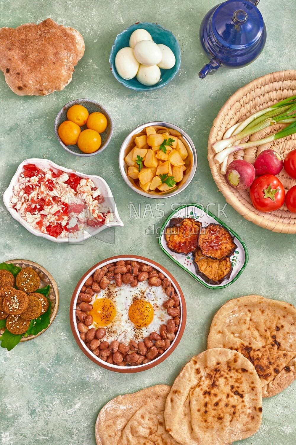 Dish of foul medames with fried egg, cheese with tomato, Arabic breakfast, oriental breakfast, arab restaurant