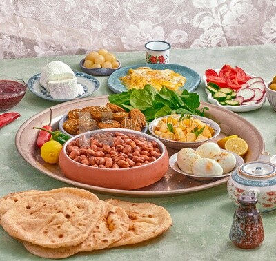 Close-up of oriental breakfast, a dish of foul medames, falafel tablets, a plate of fried egg, a plate of Boiled egg, Arabic breakfast, arab restaurant