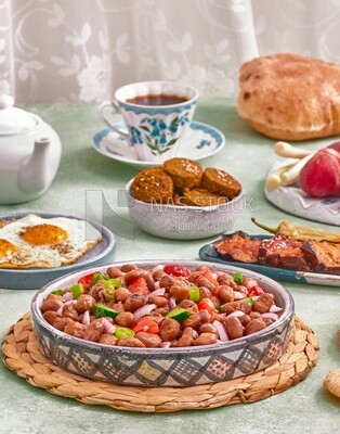 Close-up of a dish of foul medames with vegetables, Arabic breakfast, oriental breakfast, arab restaurant