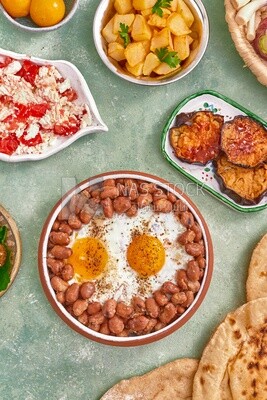 Dish of foul medames with fried egg, cheese with tomato, Arabic breakfast, oriental breakfast, arab restaurant