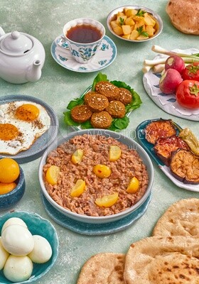 Dish of foul medames, falafel tablets, a plate of fried egg, Arabic breakfast, oriental breakfast, arab restaurant