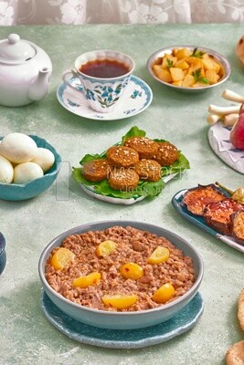 Dish of foul medames, falafel tablets, a plate of fried egg, Arabic breakfast, oriental breakfast, arab restaurant