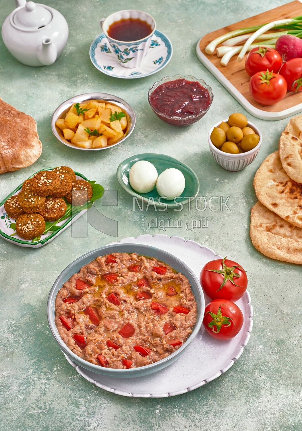 Close up of a dish of foul medames with tomato, falafel  tablets, Arabic breakfast, oriental breakfast, arab restaurant