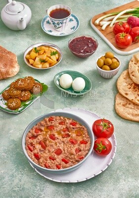 Close up of a dish of foul medames with tomato, falafel  tablets, Arabic breakfast, oriental breakfast, arab restaurant