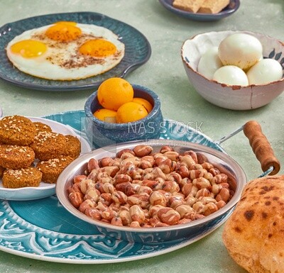 Close-up of oriental breakfast, a dish of foul medames, falafel tablets, Arabic breakfast, arab restaurant