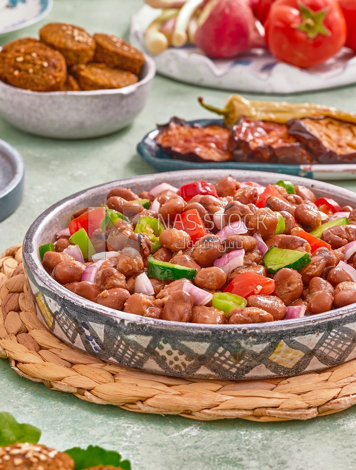 Close-up of a dish of foul medames with vegetables, Arabic breakfast, oriental breakfast, arab restaurant