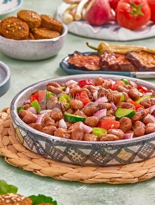 Close-up of a dish of foul medames with vegetables, Arabic breakfast, oriental breakfast, arab restaurant