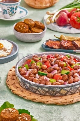 Close-up of a dish of foul medames with vegetables, Arabic breakfast, oriental breakfast, arab restaurant