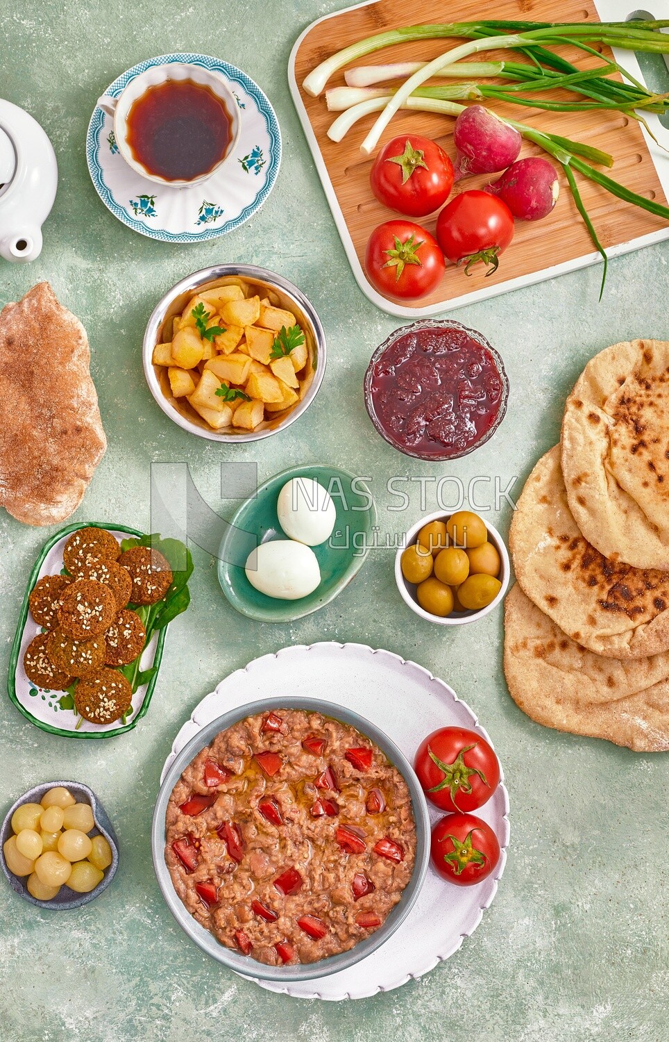 Close up of a dish of foul medames with tomato, falafel  tablets, Arabic breakfast, oriental breakfast, arab restaurant