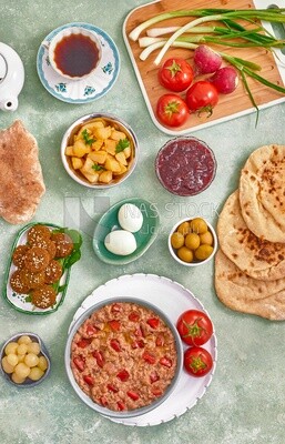 Close up of a dish of foul medames with tomato, falafel  tablets, Arabic breakfast, oriental breakfast, arab restaurant