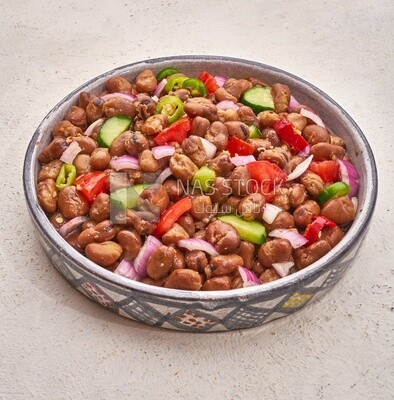Close-up of oriental breakfast, a dish of foul medames with vegetables, Arabic breakfast, arab restaurant