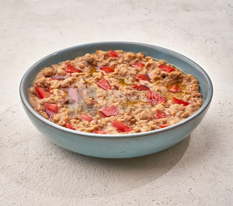 Close-up of oriental breakfast, a dish of foul medames with tomato, Arabic breakfast, arab restaurant