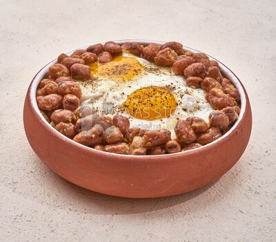 Close-up of oriental breakfast, a dish of foul medames with fried egg, Arabic breakfast, arab restaurant