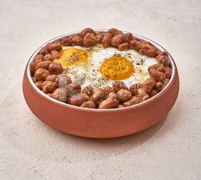 Close-up of oriental breakfast, a dish of foul medames with fried egg, Arabic breakfast, arab restaurant