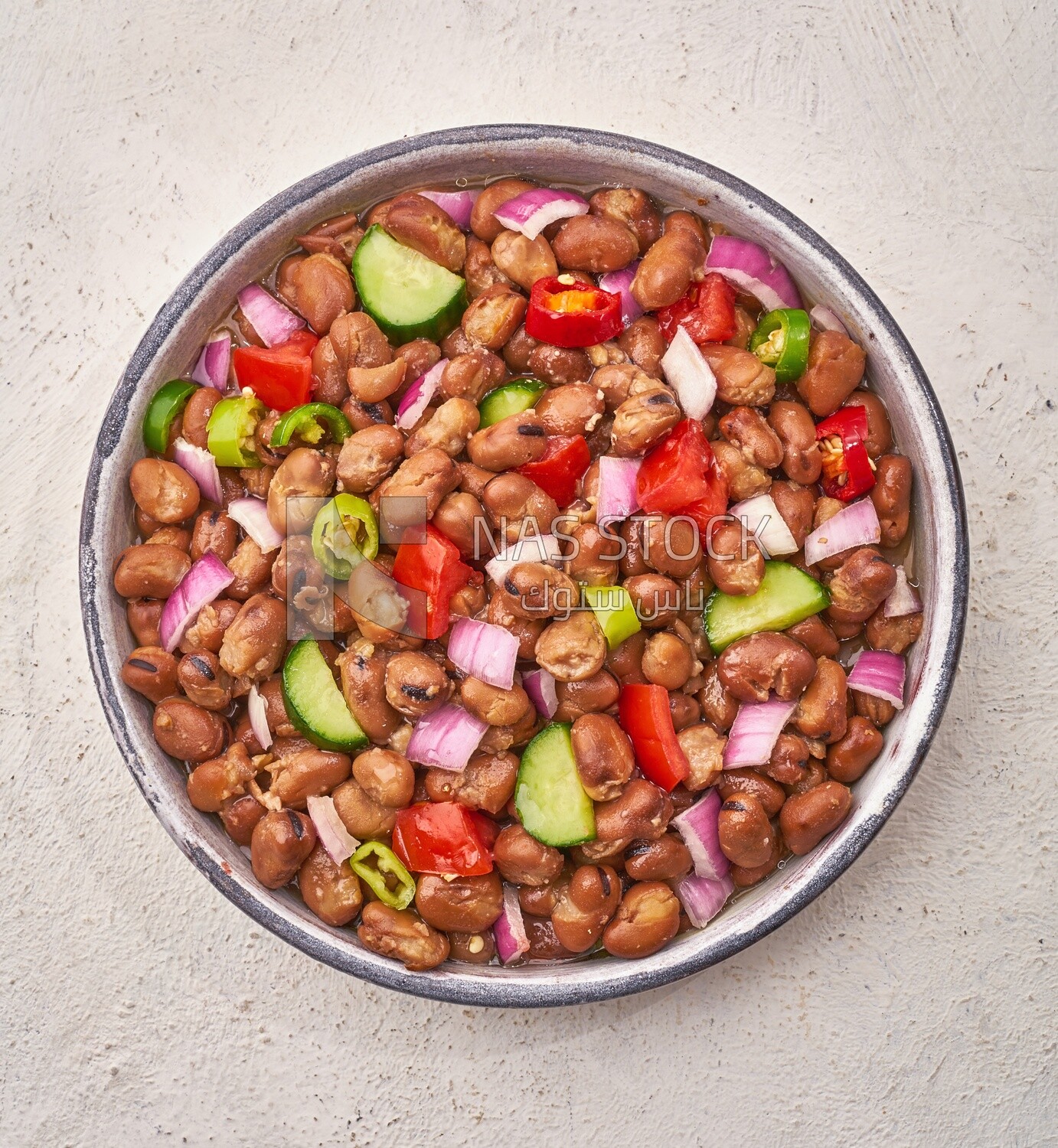 Close-up of oriental breakfast, a dish of foul medames with vegetables, Arabic breakfast, arab restaurant